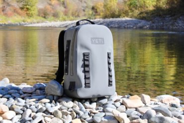 This photo shows the YETI Panga Backpack 28 on the side of a river.