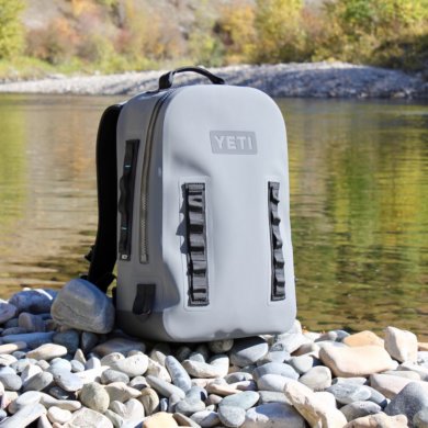 This photo shows the YETI Panga Backpack 28 on the side of a river.