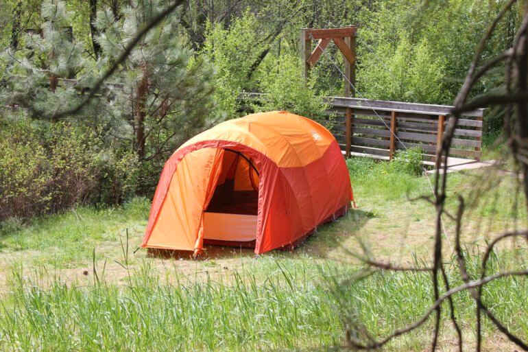 This best camping tents photo shows a camping tent set up at a campsite outside.
