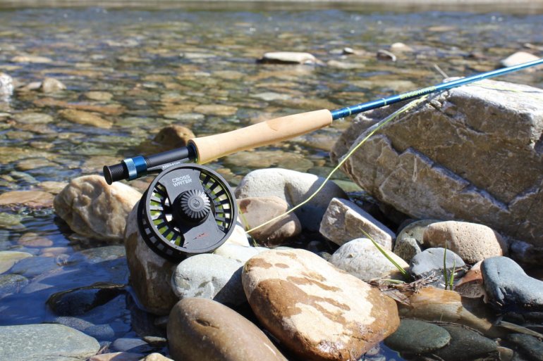 This review photo shows the Redington Crosswater Combo near a river.