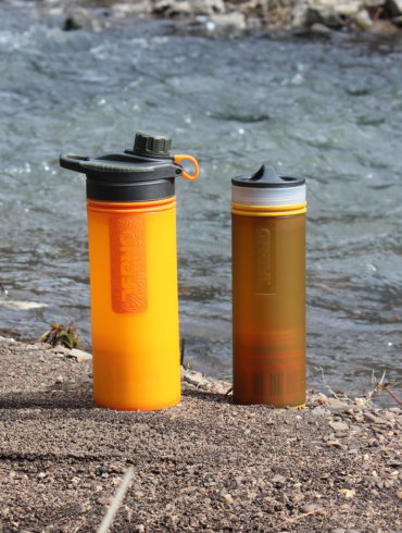 This photo shows the GRAYL GEOPRESS Purifier and GRAYL ULTRALIGHT Purifier next to a creek.