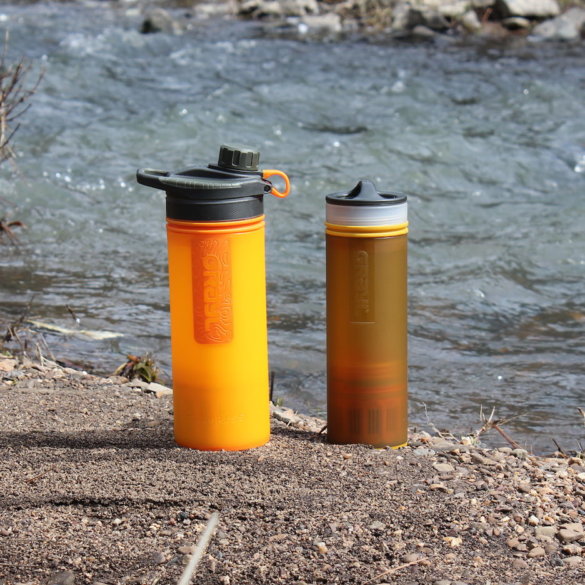 This photo shows the GRAYL GEOPRESS Purifier and GRAYL ULTRALIGHT Purifier next to a creek.