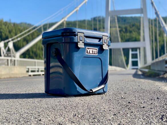 This review photo shows a closeup of the YETI Roadie 24 cooler on the edge of a road.