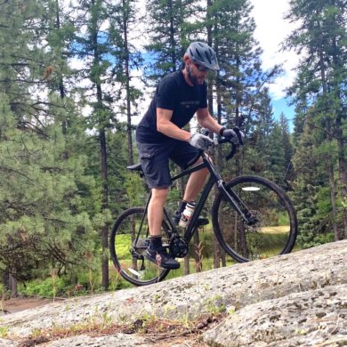 This review photo shows the author testing the Cannondale Topstone AL 105 gravel bike by riding off-road outside.