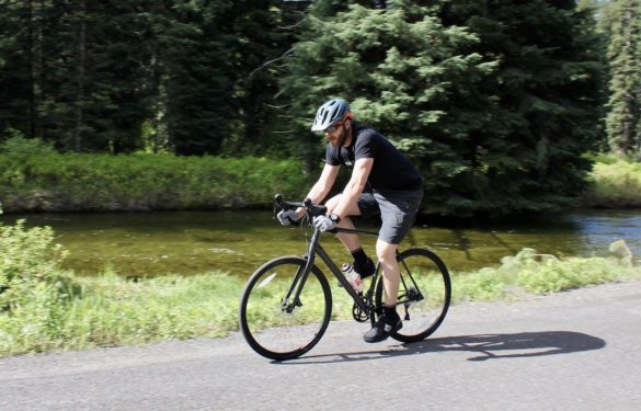 This photo shows the author riding the Cannondale Topstone AL 105 while reviewing the gravel bike.