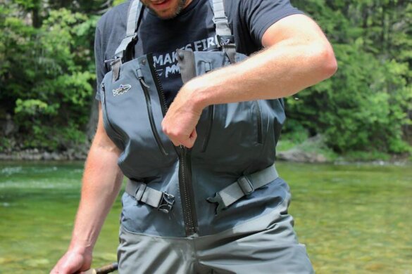 Author Chris Maxcer zips up the Patagonia Swiftcurrent Expedition Zip-Front Waders while wearing them during the testing process.