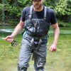 Author Chris Maxcer wearing the Patagonia Expedition Zip-Front Waders while fly fishing on a river in Idaho.