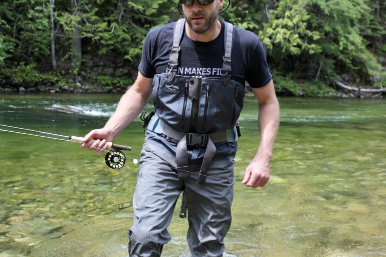 This photo shows the author testing the Patagonia Swiftcurrent Expedition Zip-Front Waders while fishing on a river.