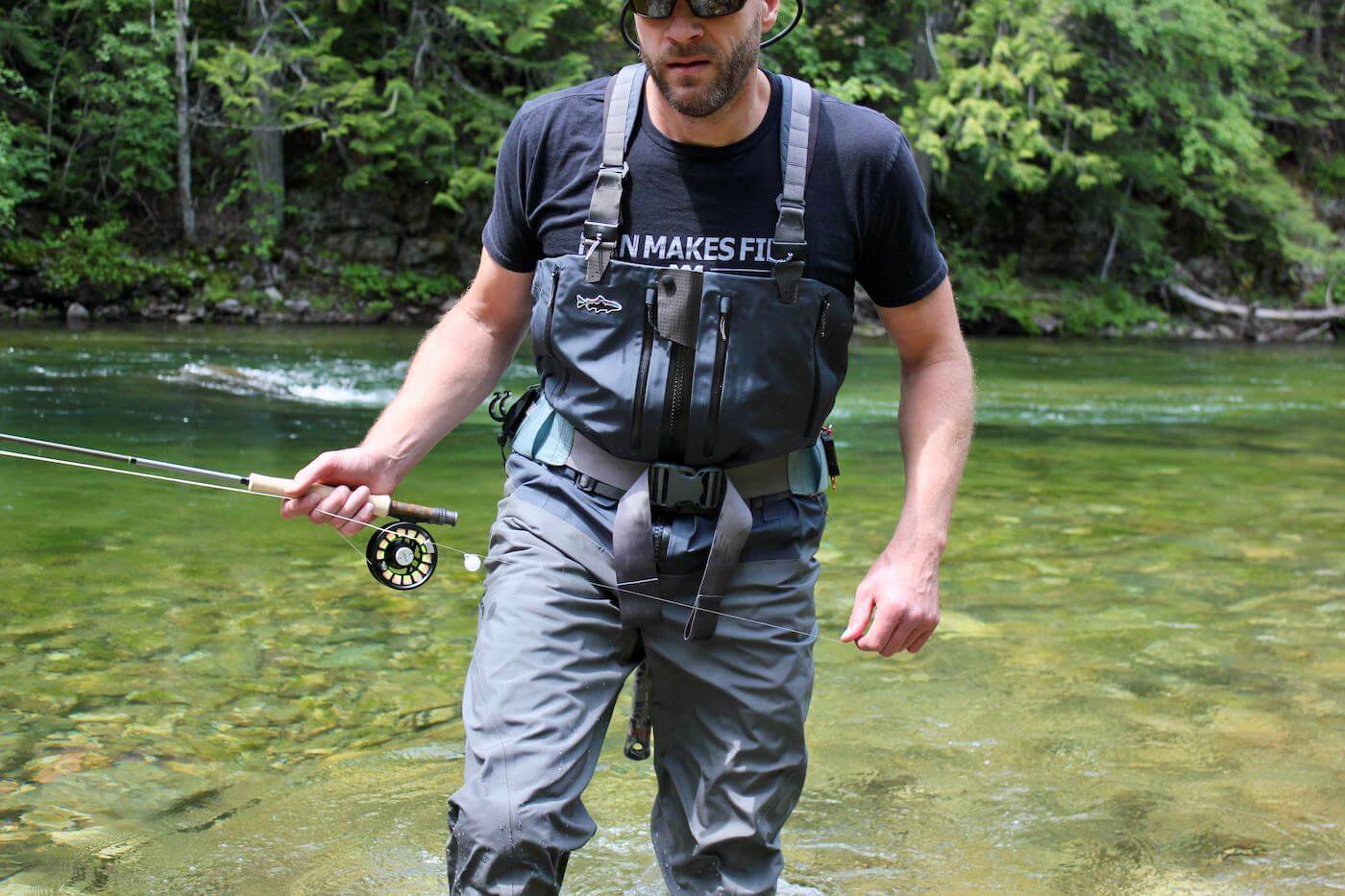 This photo shows the author testing the Patagonia Swiftcurrent Expedition Zip-Front Waders while fishing on a river.