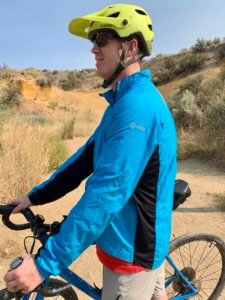 This photo shows a side view of the men's Showers Pass Ultralight Wind Jacket.