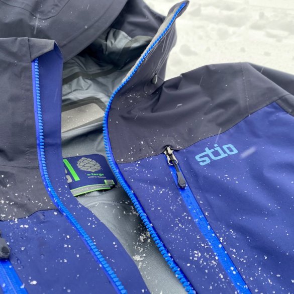 This review photo shows the Stio Objective Pro Jacket outside in a closeup with snow during the testing process.