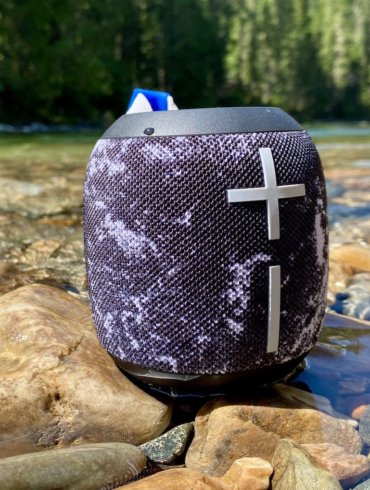 This review photo shows the Ultimate Ears Wonderboom 2 waterproof bluetooth speaker outside near a river.