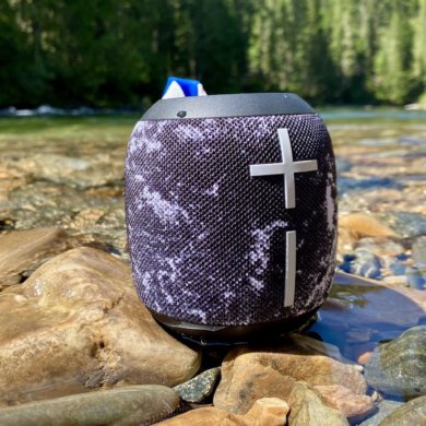 This review photo shows the Ultimate Ears Wonderboom 2 waterproof bluetooth speaker outside near a river.