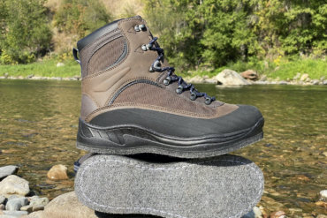 This photo shows the Cabela's Hiker Felt Sole Wading Boots next to a river.