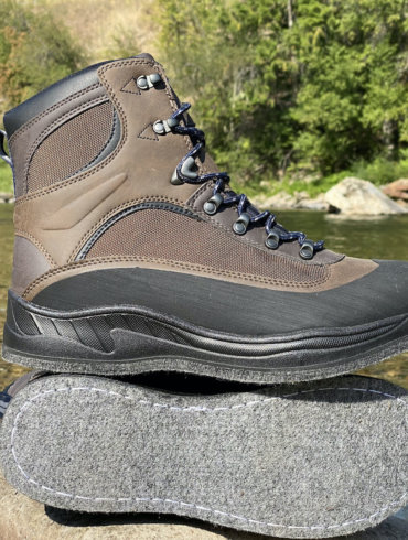This photo shows the Cabela's Hiker Felt Sole Wading Boots next to a river.