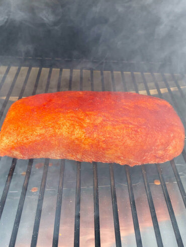 Pork loin cooking on Traeger Pro 575 Pellet Grill during the review process.