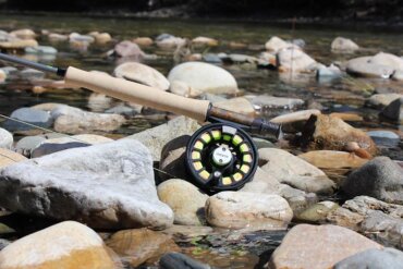 Orvis Recon Fly Rod Outfit on rocks near a trout fishing river in Idaho.