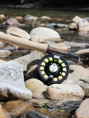 Orvis Recon Fly Rod Outfit on rocks near a trout fishing river in Idaho.