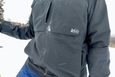 This review photo shows the author wearing the men's REI Co-op First Chair GTX Jacket during testing while skiing.