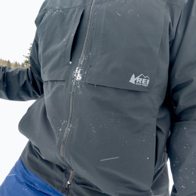 This review photo shows the author wearing the men's REI Co-op First Chair GTX Jacket during testing while skiing.