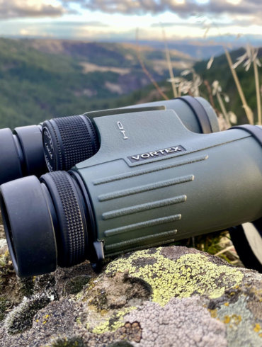 This review photo shows the author's Vortex Viper HD 10x42 binoculars outside during a hunting trip.