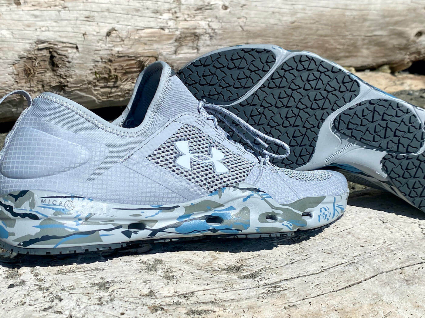 This review photo shows the men's UA Kilchis Fishing Shoes on a log at the beach.