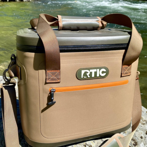 This review photo shows the RTIC Soft Pack 30 Cooler next to a river.