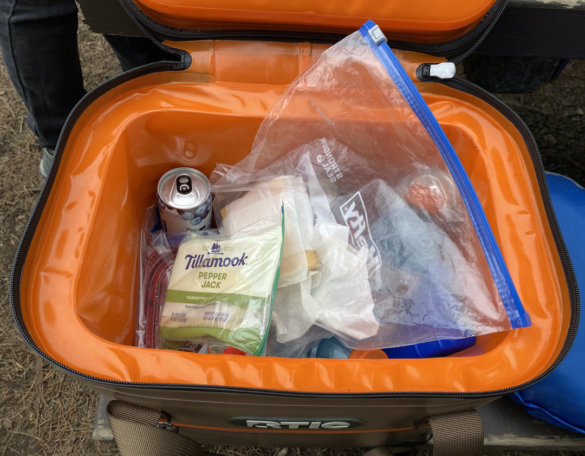 This review photo shows the RTIC Soft Pack 30 Cooler full of lunch food and drinks during the testing process.