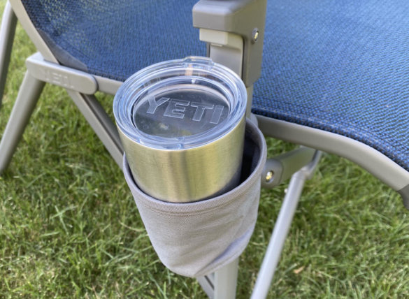 This photos shows the YETI Trailhead Camp Chair cupholder with a YETI cup in it.