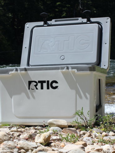 This review photo shows the RTIC Ultra-Light Cooler outside near a river just prior to the testing process by the author.