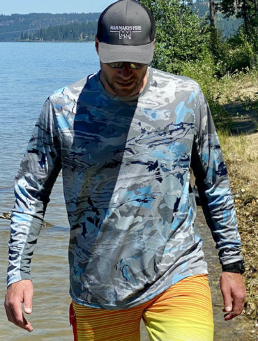 This review photo shows the author testing a Under Armour UA Iso-Chill Shorebreak Long Sleeve fishing shirt on a sunny beach.