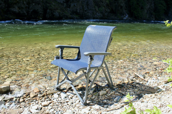 This review photo shows the YETI Trailhead Camp Chair setup outside near a river during the testing and review process.