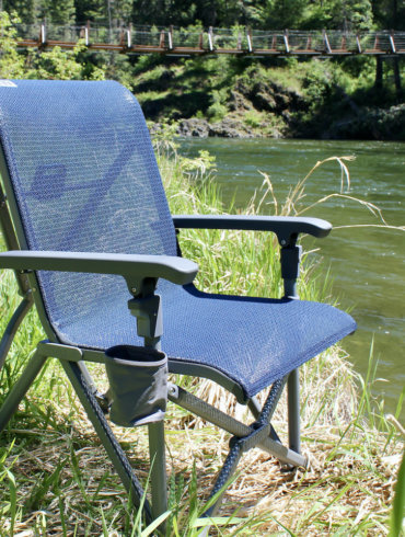 This review photo shows the YETI Trailhead Camp Chair near a river during the testing process by the author.