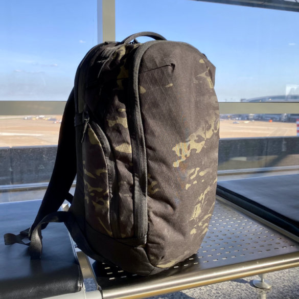 This review photo shows the Able Carry Max Backpack on a bench in an airport during the testing and review process.