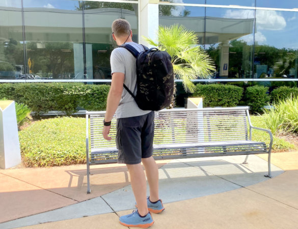 This photo shows the author wearing the Able Carry Max Backpack at an airport.