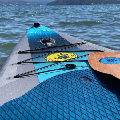 This review photo shows the Body Glove Performer 11 stand-up paddle board on a lake during the testing process.