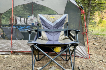 This photo shows the Cabela's Big Outdoorsman XL Fold-up Chair set up at a camping site.