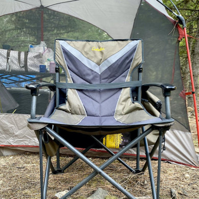 This photo shows the Cabela's Big Outdoorsman XL Fold-up Chair set up at a camping site.
