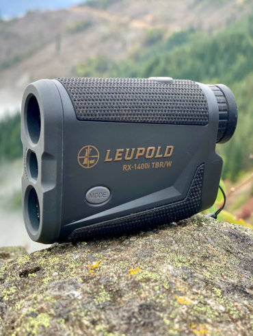 This review photo shows the Leupold RX-1400i TBR/W Rangefinder outside on a rock.