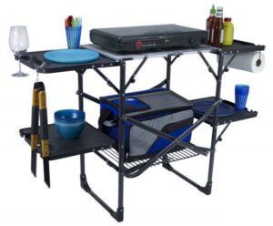 This camping gear gift shows the GCI Outdoor Slim-Fold Cook Station for camp cooking.