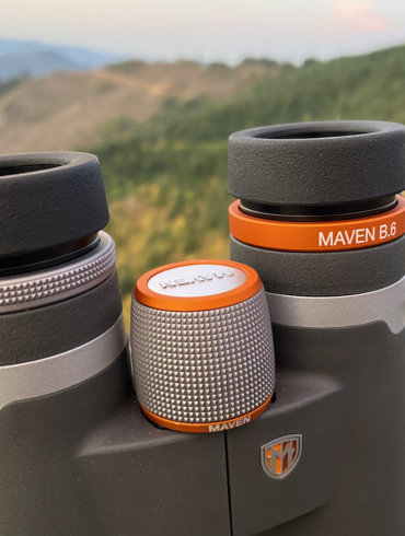 This review photo shows the Maven B.6 Binocular in the 12x50 configuration outside on a mountain top during the testing process.