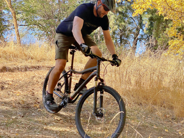 This photo shows the author riding the DRT 1.1 bike down a hill.