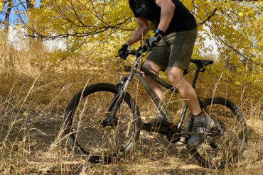 This photo shows the author riding the REI Co-op Cycles DRT 1.1 Bike on a trail during the testing and review process.