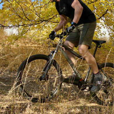 This photo shows the author riding the REI Co-op Cycles DRT 1.1 Bike on a trail during the testing and review process.