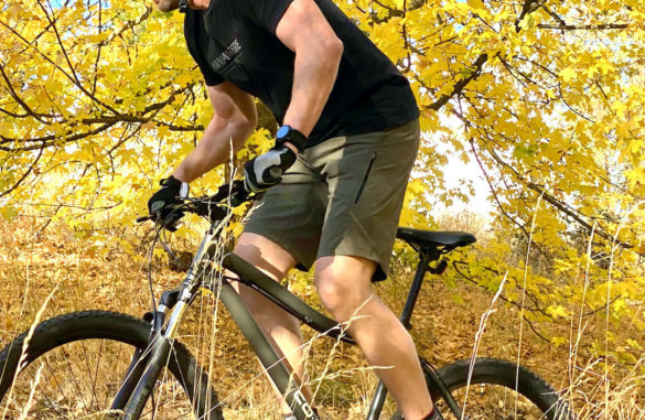 This photo shows a closeup of the Showers Pass Apex DWR 12" Shorts being worn by the author during a test mountain biking ride.