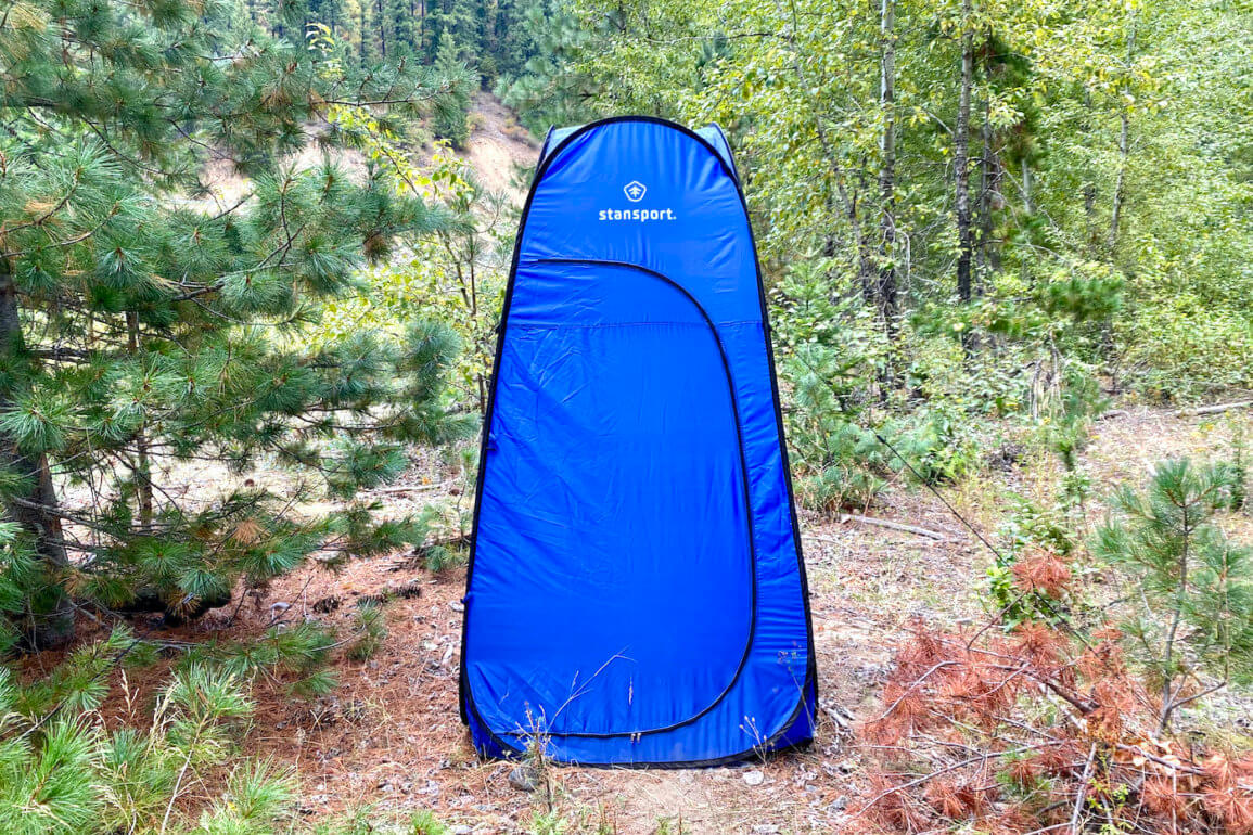 This review photo shows the Stansport Pop-Up Privacy Shelter set up at a remote campsite during the testing process.