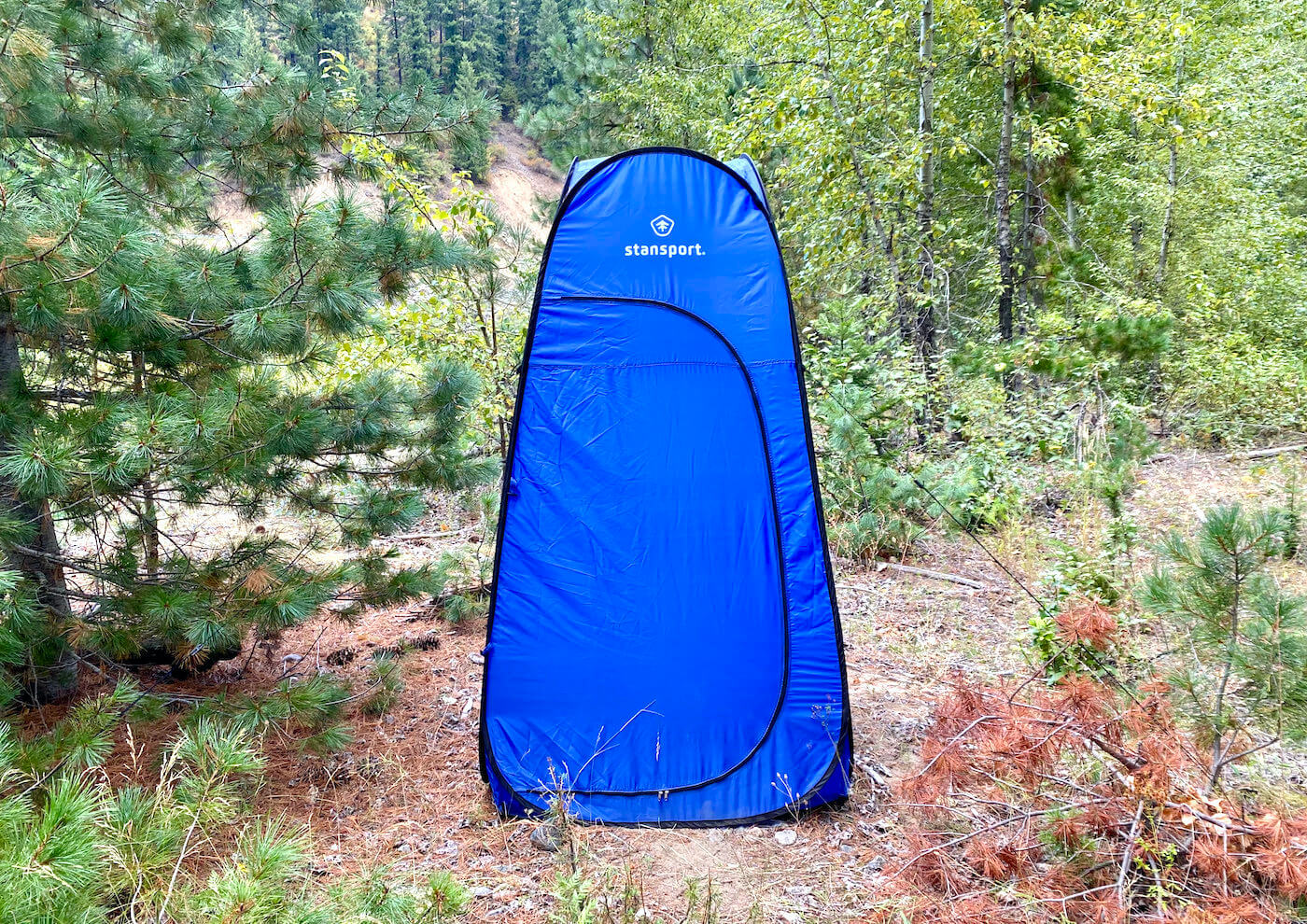This review photo shows the Stansport Pop-Up Privacy Shelter set up at a remote campsite during the testing process.