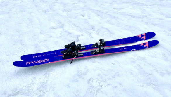 This photo shows the Fischer Ranger 94 FR skis with bindings on a ski hill.