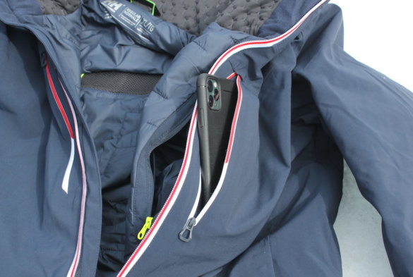 This photo shows the Life Pocket with a smartphone inside of it on the Helly Hansen Alpha Lifaloft Jacket.