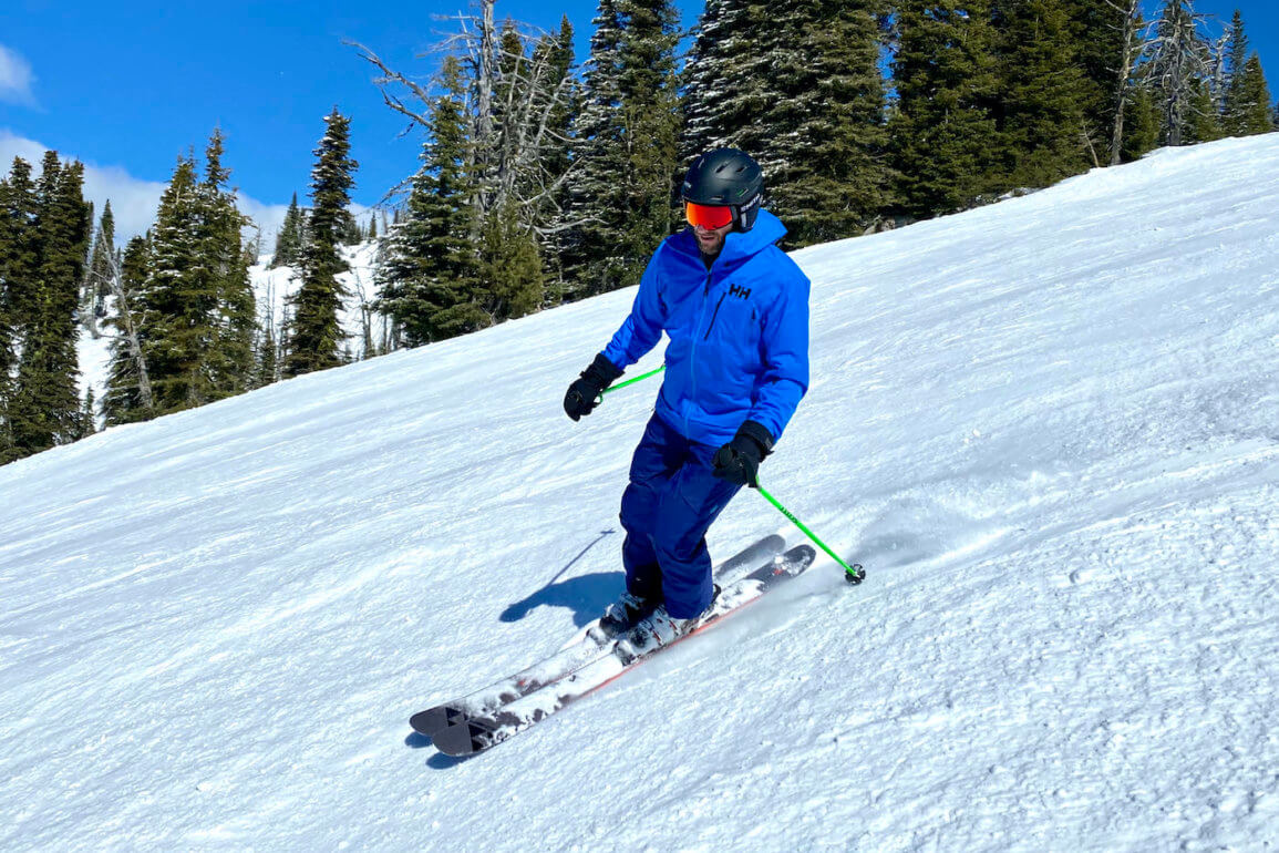 This photo shows the author wearing the men's Helly Hansen Odin 9 Worlds 2.0 Outdoor Shell Jacket while skiing during the testing and review process.